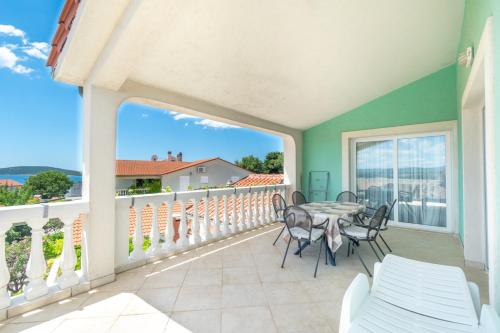 a patio with a table and chairs on a balcony at Apartments Katarine Zrinske in Vodice