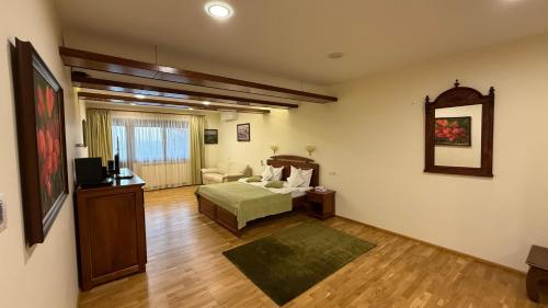 a living room with a bed and a couch at Holbina Trei Bibani - Delta Dunarii in Dunavăţu de Jos