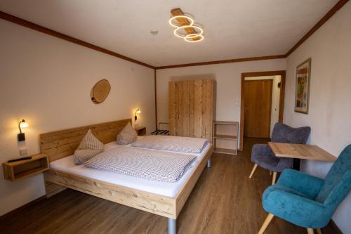 a bedroom with a bed and a table and chairs at Hotel Pension Tyrol in Seefeld in Tirol