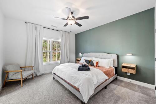 a bedroom with a bed and a ceiling fan at Creekside Cabin, Sauna, Near Wineries and BJ Reece in Talking Rock