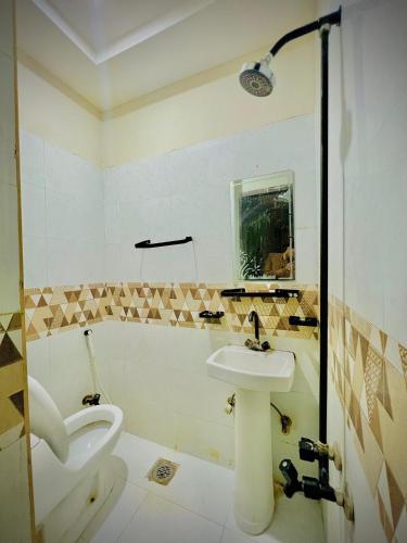 a bathroom with a sink and a toilet at AL AQSA SUiTES Guest House Islamabad in Islamabad
