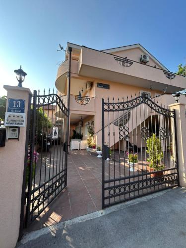 a gate in front of a building at Apartmani Relax D in Tivat