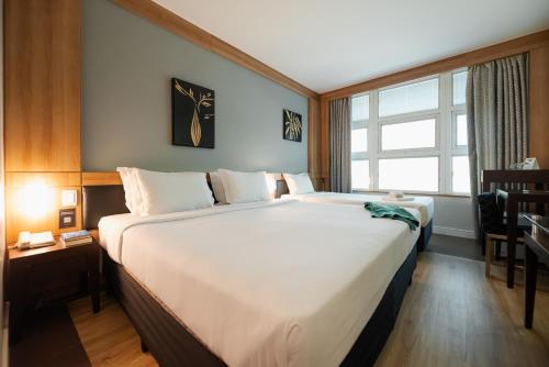 Cama ou camas em um quarto em Intercity Vinhedo