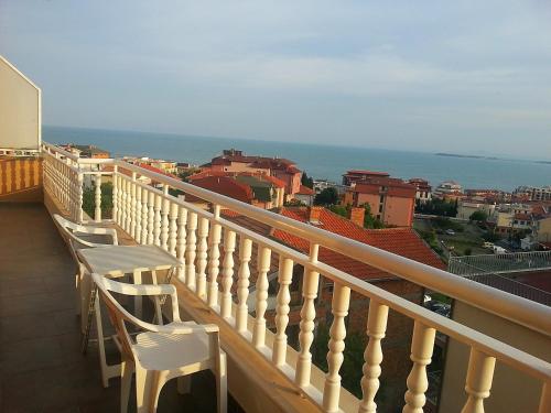 a balcony with chairs and a view of the ocean at Guest House Rona - Free Parking and Sea View in Sveti Vlas