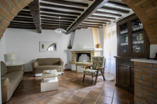 a living room with a couch and a fireplace at Apartment in the medieval village in Montefollonico
