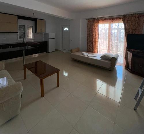 a living room with a couch and a table at Valedeti Apartments Ksamil in Ksamil