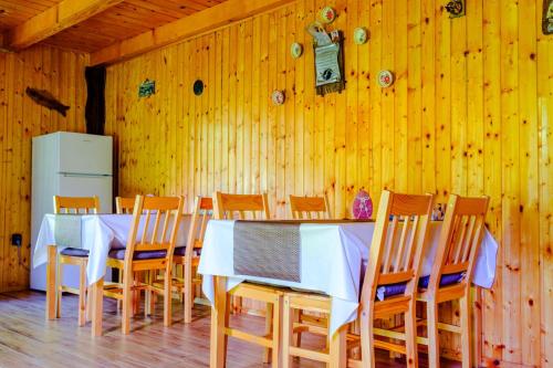 a dining room with a white table and chairs at Casa Bunicii in Costeşti