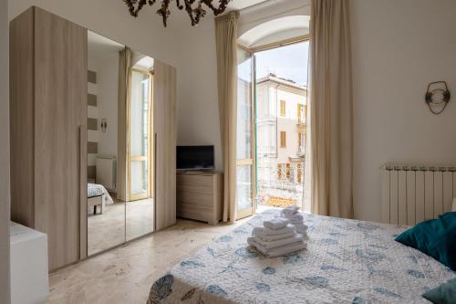 a bedroom with a bed and a large window at blu sea in La Spezia