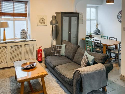 a living room with a couch and a table at The Nest in Llandeilo