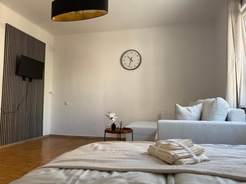 a bedroom with a bed and a clock on the wall at GRAZis Apartments in Graz