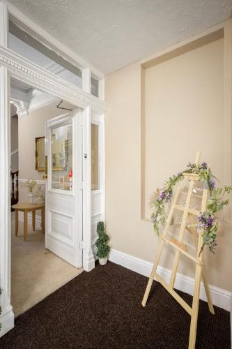 a room with a ladder and a door with flowers at Hotel Sofia Blackpool in Blackpool