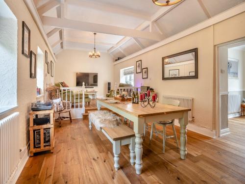 a dining room with a table and chairs at Miners Arms Cottage in Stepaside