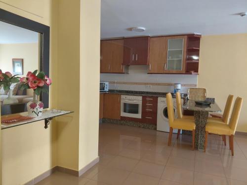a kitchen with a table and a dining room at Apartamentos As Caldelas in O Grove