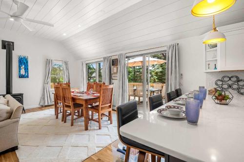 a kitchen and living room with a table and chairs at Walk to Pond 2 Min Drive to Beach in Eastham