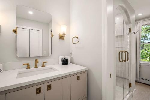 a white bathroom with a sink and a shower at Walk to Pond 2 Min Drive to Beach in Eastham
