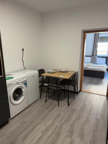 a living room with a table and a washing machine at GRAZis Apartments in Graz