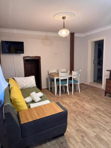 a living room with a couch and a table at Pangea Sığacık Suite Hotel & Bistro in Seferihisar