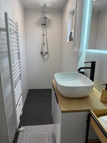 a bathroom with a white sink and a shower at GRAZis Apartments in Graz