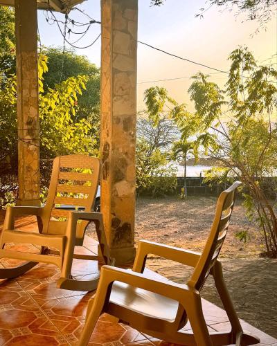 a group of chairs sitting on a porch at Sunset House in Transito