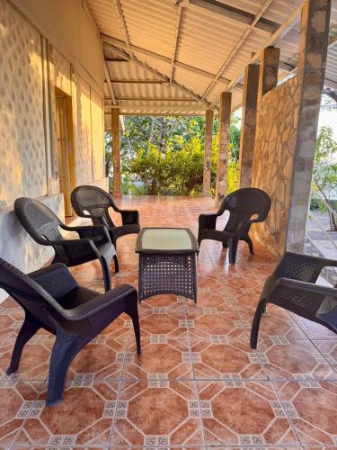 a group of chairs and a table on a patio at Sunset House in Transito