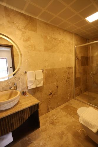 a bathroom with a sink and a shower at Erdu Cappadocia Stone House in Avanos