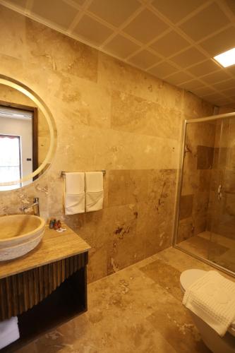 a bathroom with a sink and a shower at Erdu Cappadocia Stone House in Avanos