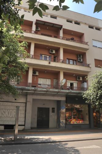 an apartment building with balconies on the side of it at Loft Apartment in Podgorica