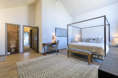 a bedroom with a large canopy bed and a desk at Large 4 Bedroom Home with Hot Tub and Fenced Yard - NO XTRA FEES! in Grand Junction