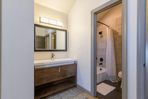 a bathroom with a sink and a mirror at Large 4 Bedroom Home with Hot Tub and Fenced Yard - NO XTRA FEES! in Grand Junction