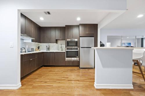a kitchen with stainless steel appliances and wooden cabinets at The Lenox in New York