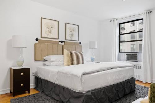 a white bedroom with a large bed and a window at The Lenox in New York