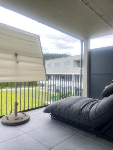 a bedroom with a bed and a large window at LiMax in Ledenitzen