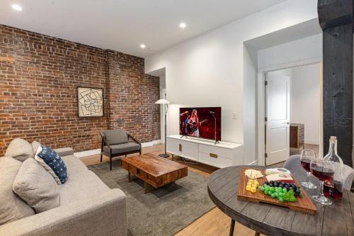 a living room with a couch and a table at The Saddlery-Tracklist-2 Units-Walk to Broadway in Nashville
