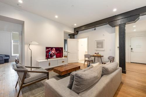 a living room with a couch and a table at The Saddlery-Tracklist-2 Units-Walk to Broadway in Nashville