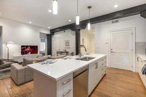 an open kitchen and living room with a couch at The Saddlery-Tracklist-2 Units-Walk to Broadway in Nashville