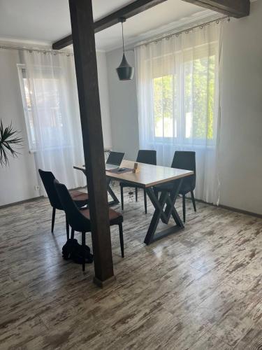 a dining room with a table and chairs with two laptops at SeaLine Odessa in Kryzhanivka