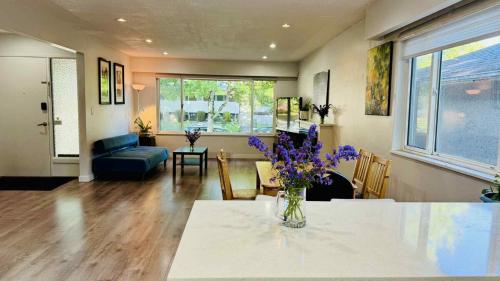 a living room with a vase of flowers on a table at Cozoro 3 BEDROOMS Centre Vancouver in Vancouver