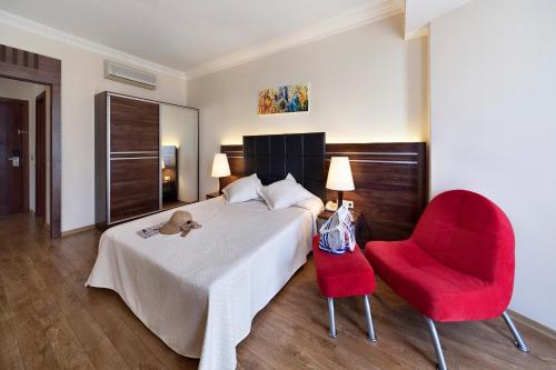 A bed or beds in a room at Golden Age Hotel Yalıkavak Bodrum