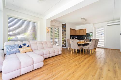 a living room with a couch and a table at Keszeg Villa Zamárdi in Zamárdi
