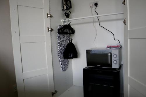 a room with a door and a tv and a closet at Harbourside Hotel in Irvine
