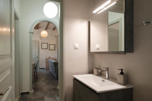 a bathroom with a sink and a mirror at Sofia Apartments in Sidari