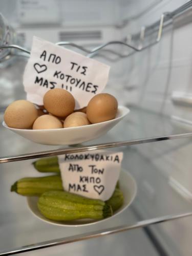 two bowls of eggs and vegetables with signs on them at Casa Negiada in Agios Nikolaos