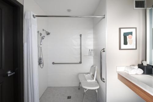 a bathroom with a shower and a toilet and a sink at Holiday Inn Hotel & Suites Surrey East - Cloverdale by IHG in Surrey
