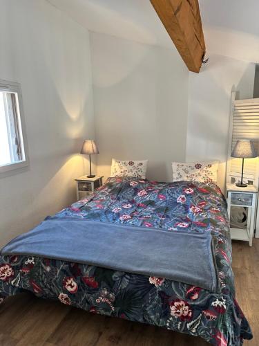 - une chambre avec un lit avec une couette bleue et 2 lampes dans l'établissement Exclusive Beachfront Luxury!, à Gruissan