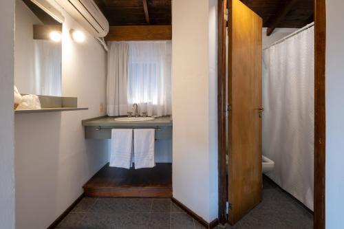 a bathroom with a sink and a toilet at POSADA NEHUEN in Villa General Belgrano