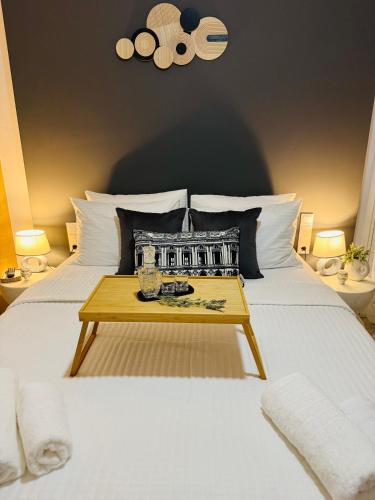 a bedroom with a bed with a table on it at Casa Negiada in Agios Nikolaos