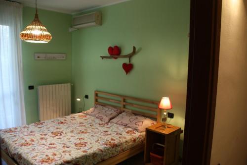 a bedroom with a bed and a table with a lamp at Sotto la Rocca in Angera