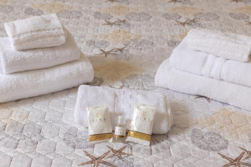 a group of towels and towels on a bed at blu sea in La Spezia