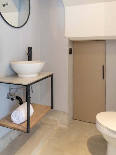 a bathroom with a sink and a toilet at Hotel Santa Ana Medellin in Medellín