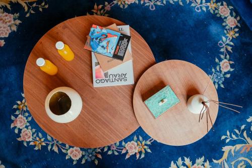a wooden table with a plate withiversary olympics items on it at Guest Rooms Jardín Prim in Mexico City